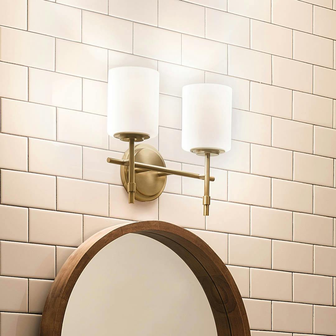 Night time bathroom with Ali 11.5" 2 Light Vanity Brushed Natural Brass