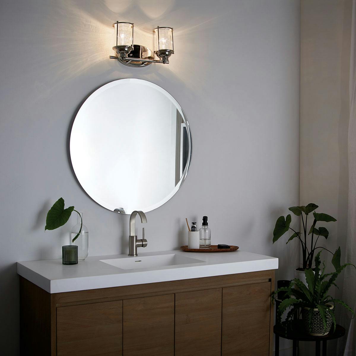 Night time bathroom image featuring Ashland Bay vanity light 45771PN