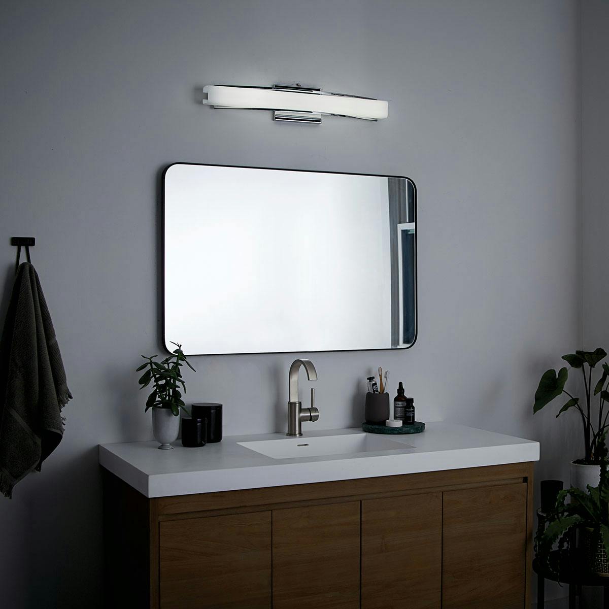 Night time bathroom image featuring Rowan vanity light 83758