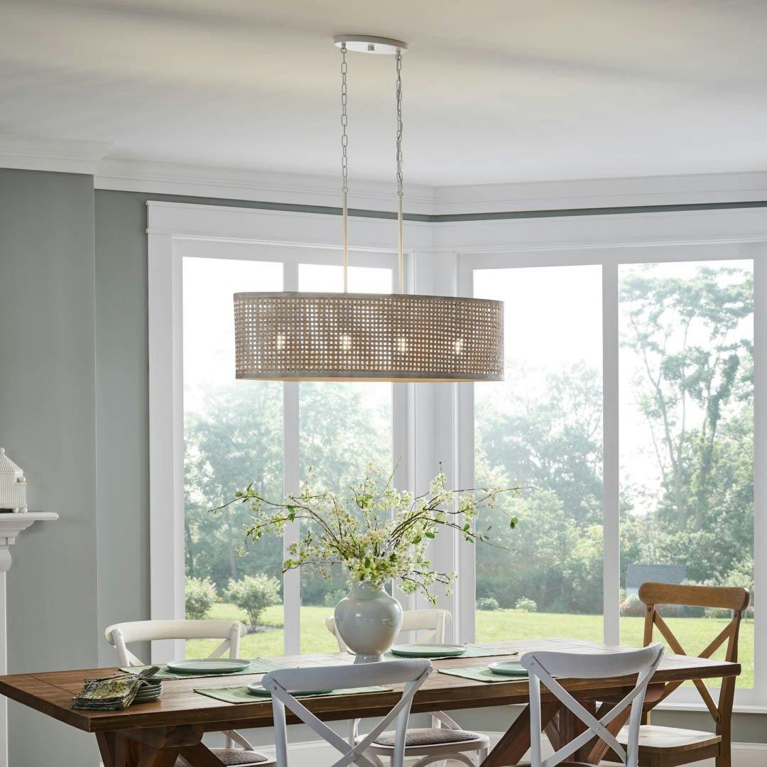 Day time dining room with Sayulita 4 Light Chandelier Oval Pendant in White and White Washed Wicker
